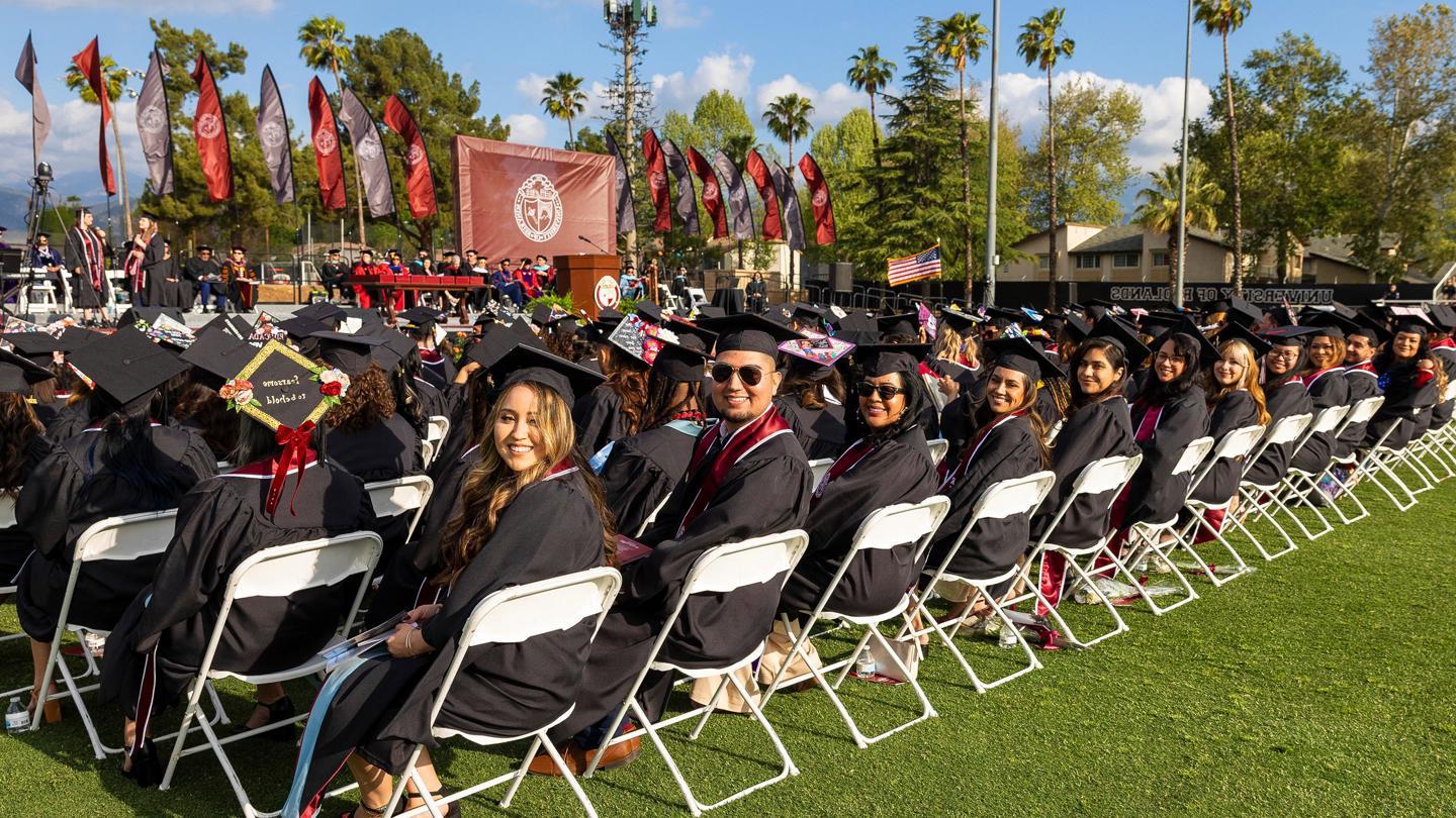 Row of students smiling for photo during Commencement.